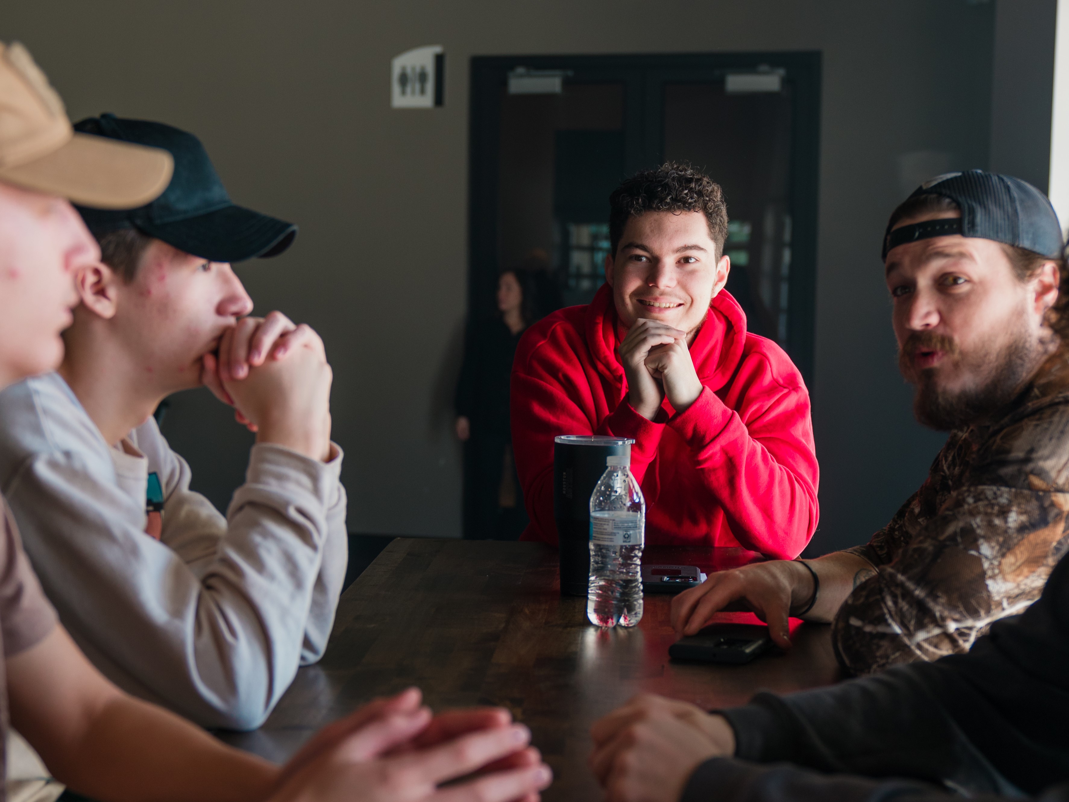 youth leader engaging male students in church bible study